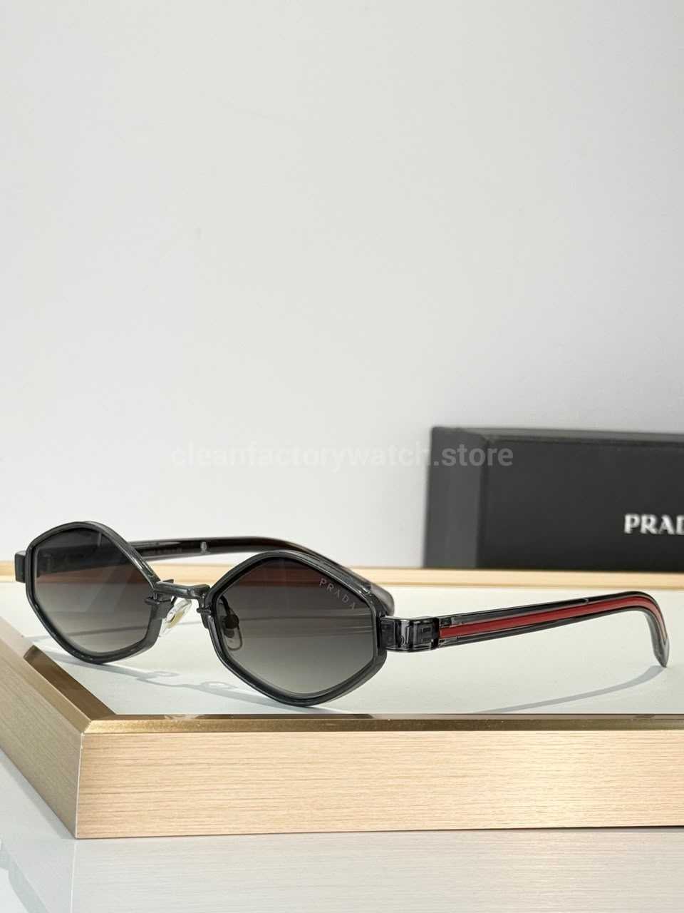 Prada SPS05X Geometric Sunglasses | Transparent Smoke Grey Frame, Red Temple Stripes & Grey Gradient Lenses